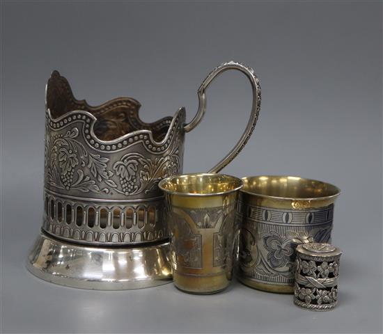 A 19th century Russian gilt 84 zolotnik tot, a later beaker, a Podstakannik and a coin holder?